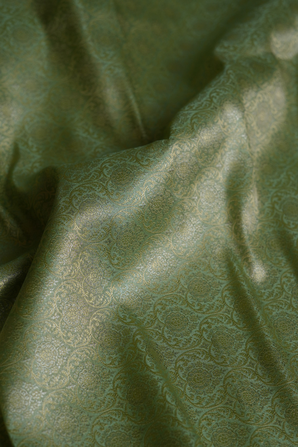 Semi Silk Brocade Fabric in Green with Floral and Paisley Motifs